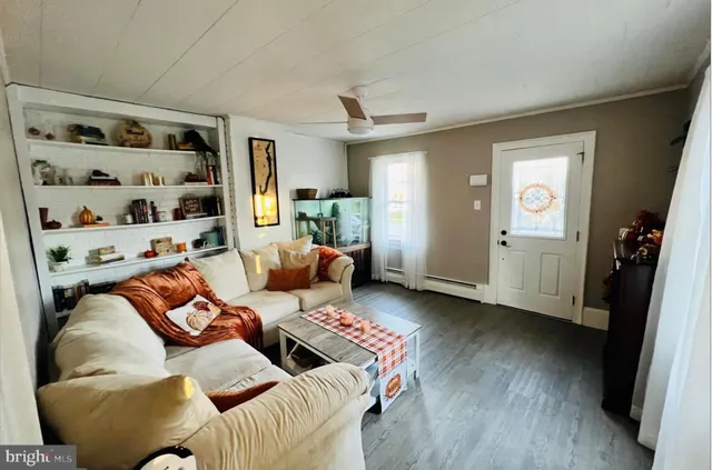 a living room with furniture and wooden floor
