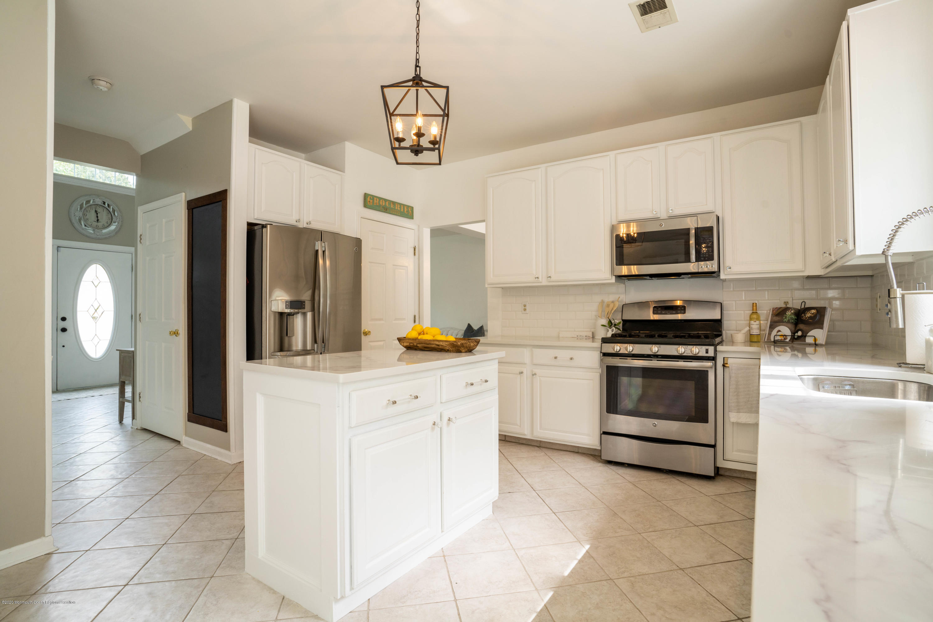 2 Sun Hollow Road Howell, NJ 07731 - Photo 4 of 34 a kitchen with stainless steel appliances and white cabinets