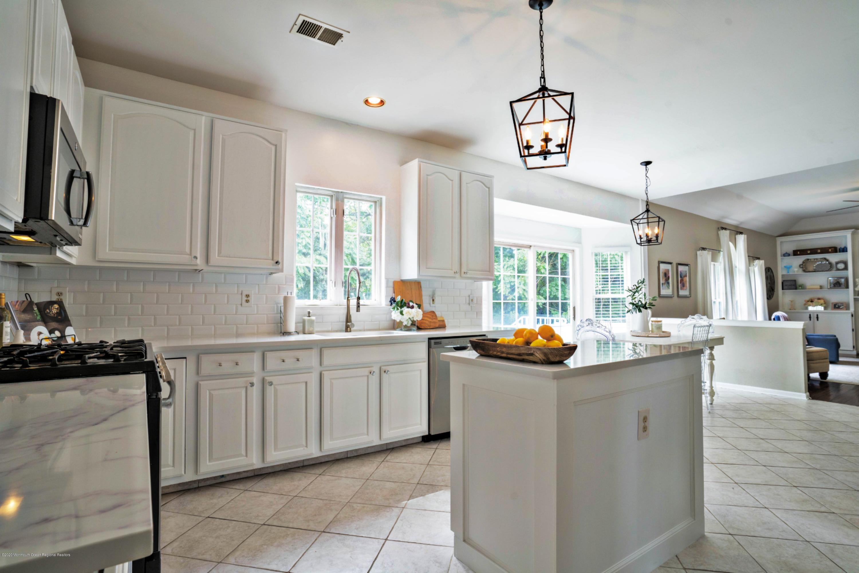 2 Sun Hollow Road Howell, NJ 07731 - Photo 5 of 34 a kitchen with granite countertop a sink and a stove top oven