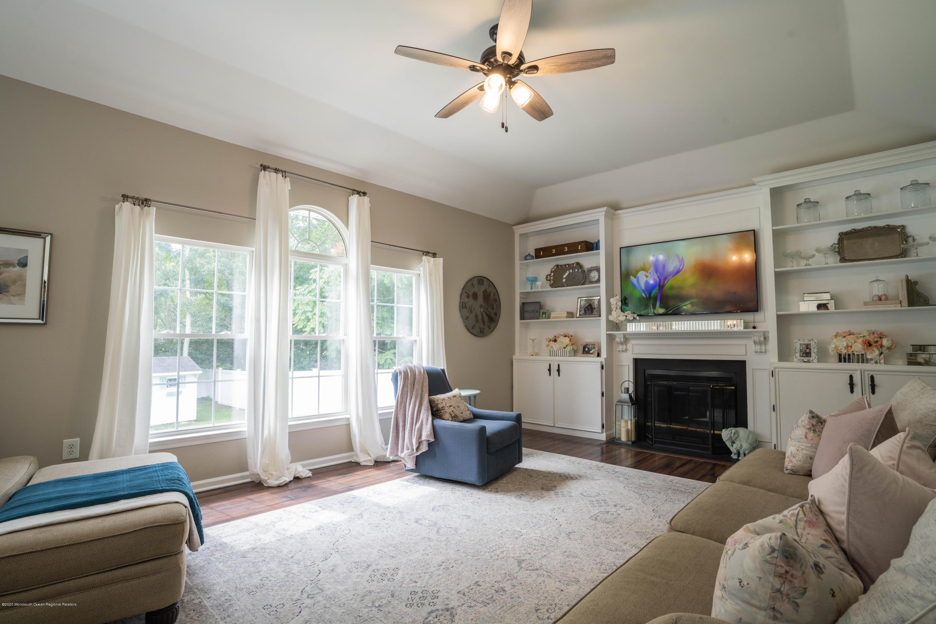 2 Sun Hollow Road Howell, NJ 07731 - Photo 10 of 34 a living room with furniture a flat screen tv and a fireplace