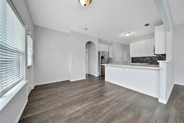a view of a kitchen with a sink cabinets and wooden floor