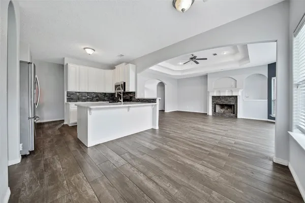 a view of kitchen with sink and wooden floor