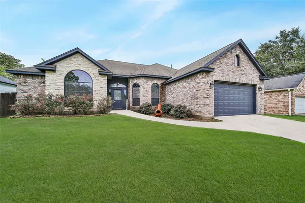 a front view of house with yard and green space