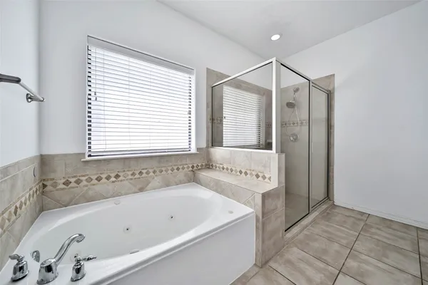 a bathroom with a bathtub and a shower