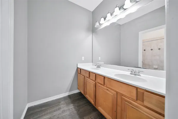 a spacious bathroom with a double vanity sink and a mirror