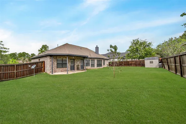 a view of a house with a yard and sitting area