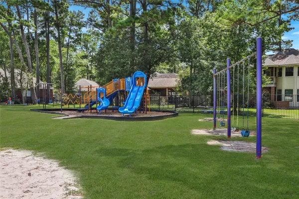 a view of a park with swings and slides