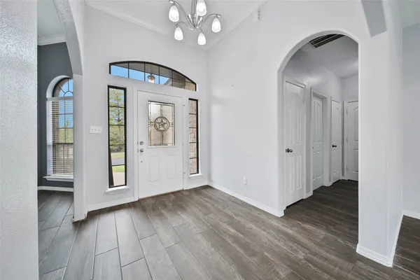 a view of an entryway with wooden floor