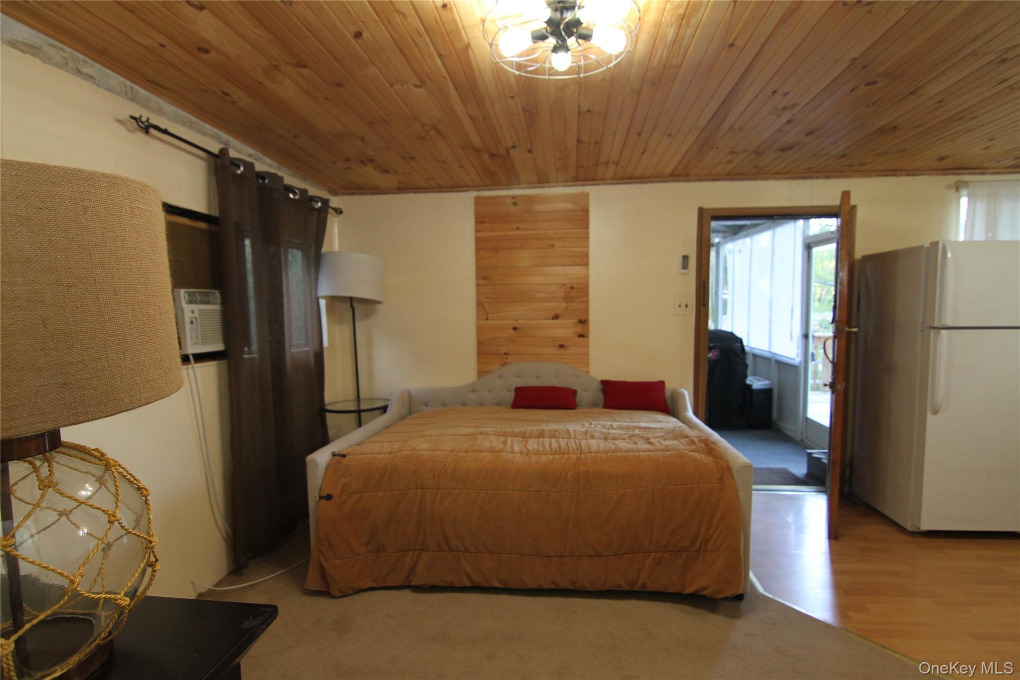 191 Sylvan Lake Road, Unit 16 Hopewell Junction, NY 12533 - Photo 11 of 34 a bedroom with a bed and a refrigerator