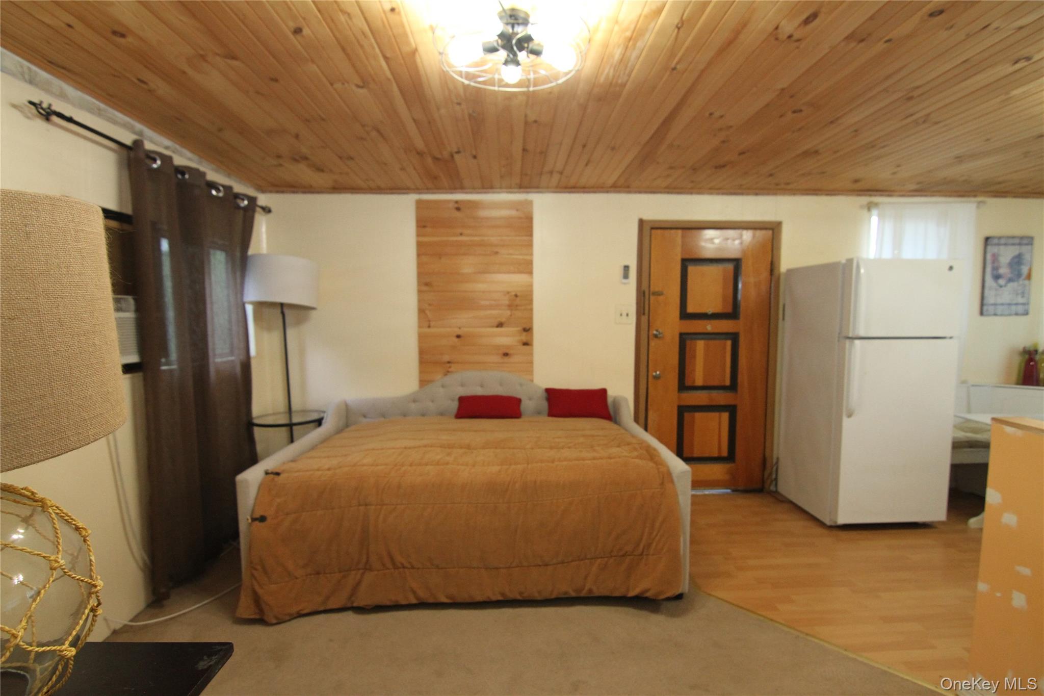 191 Sylvan Lake Road, Unit 16 Hopewell Junction, NY 12533 - Photo 12 of 34 a bedroom with a bed and a refrigerator