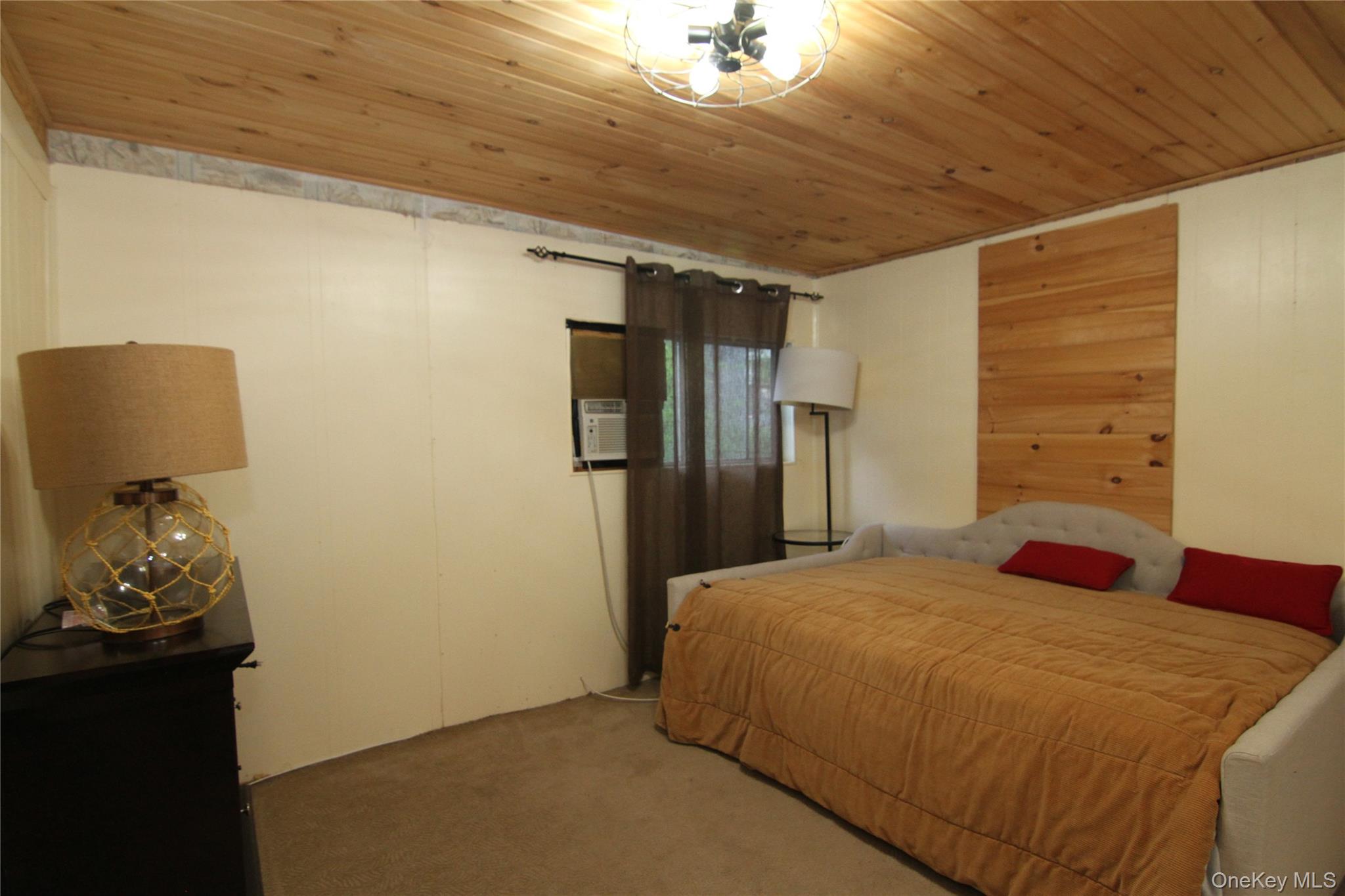 191 Sylvan Lake Road, Unit 16 Hopewell Junction, NY 12533 - Photo 13 of 34 a bed room with a bed and a television