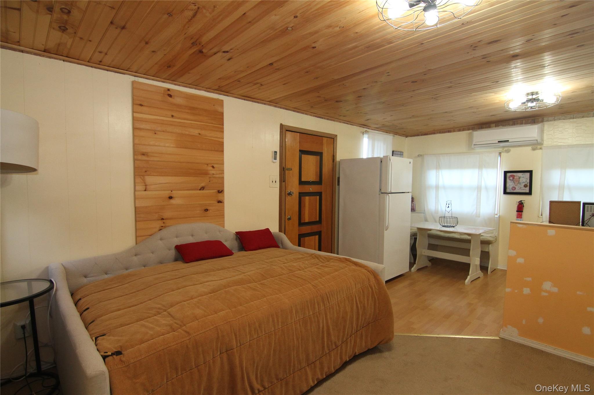 191 Sylvan Lake Road, Unit 16 Hopewell Junction, NY 12533 - Photo 14 of 34 a bedroom with a bed and a table in it