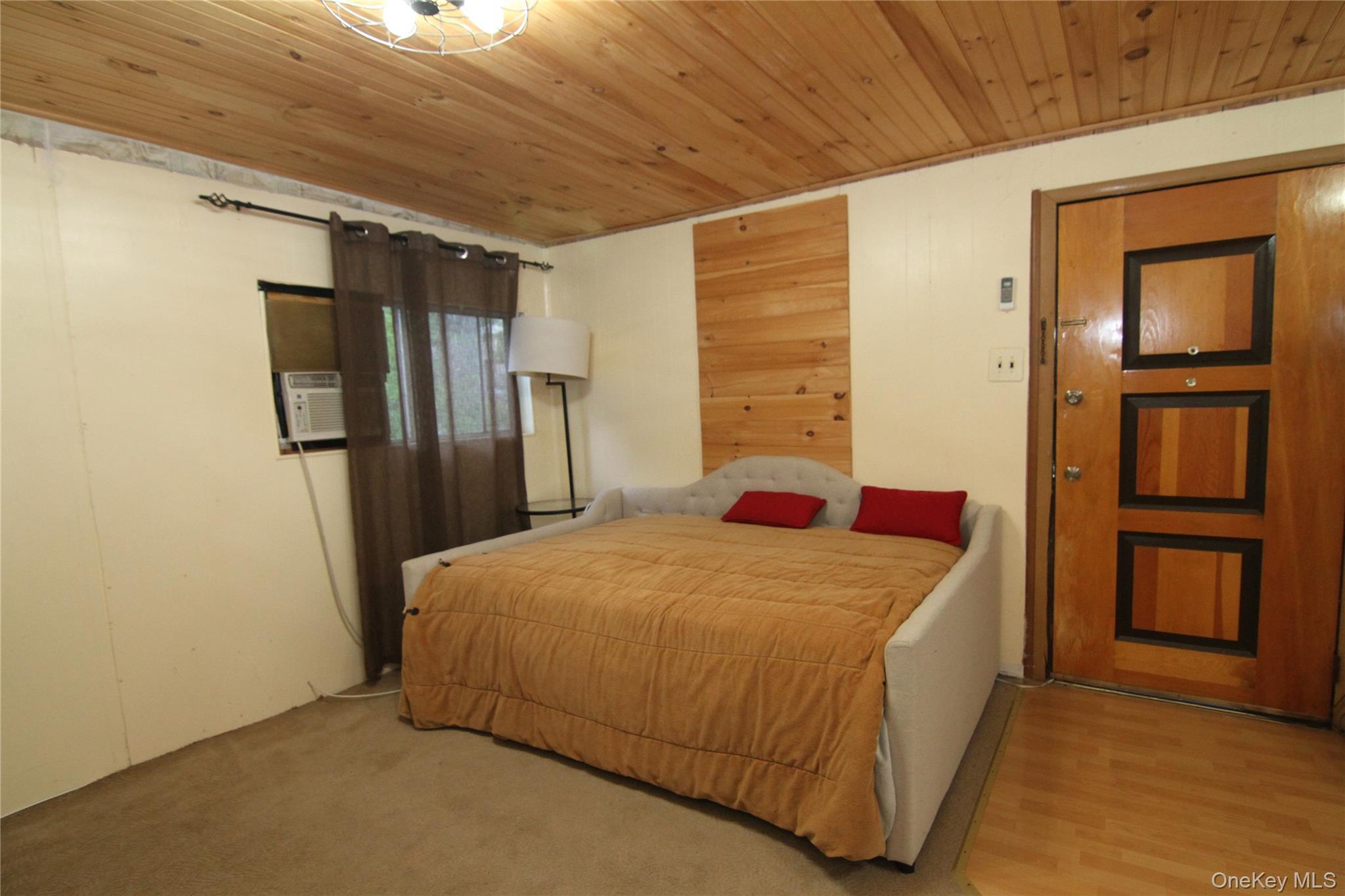 191 Sylvan Lake Road, Unit 16 Hopewell Junction, NY 12533 - Photo 15 of 34 a bedroom with a bed and wooden floor