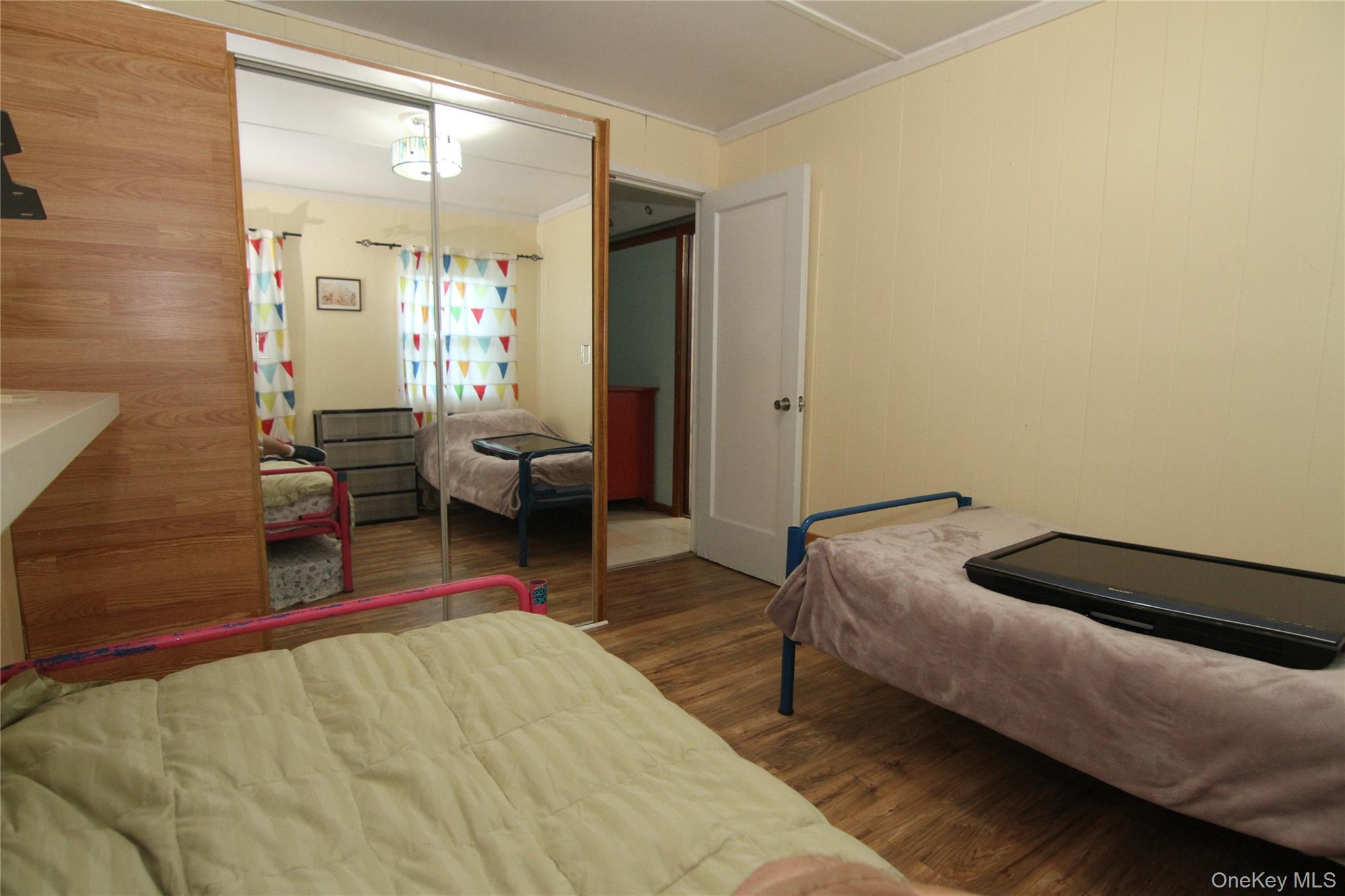 191 Sylvan Lake Road, Unit 16 Hopewell Junction, NY 12533 - Photo 26 of 34 a bedroom with a bed and wooden floor