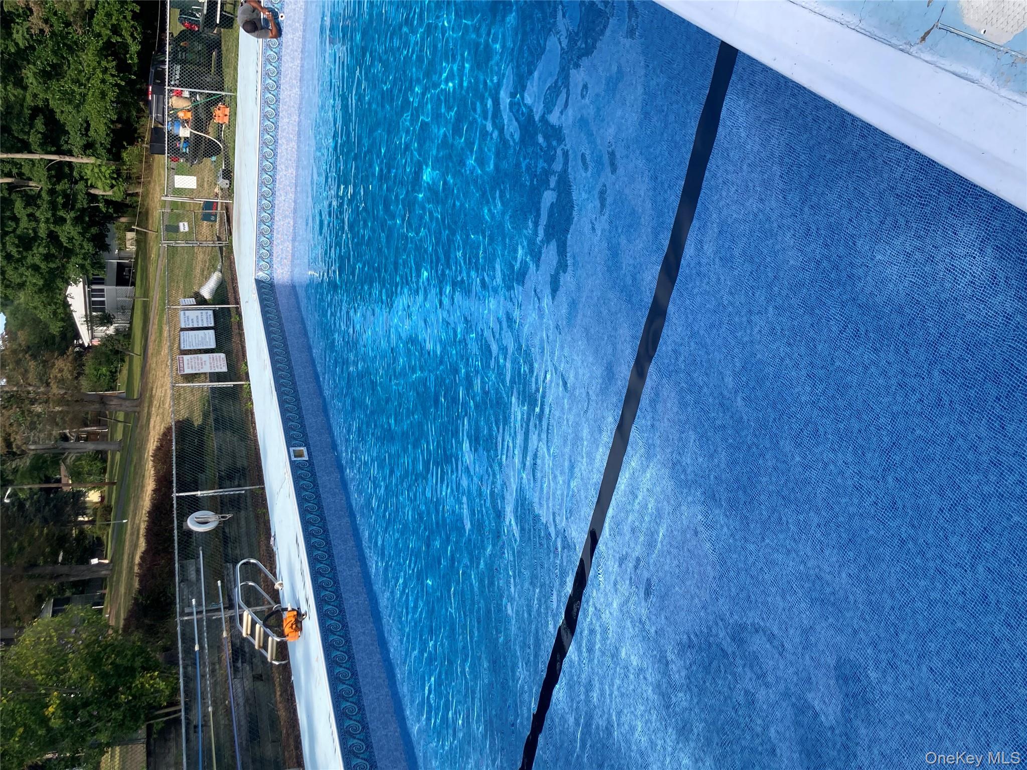 191 Sylvan Lake Road, Unit 16 Hopewell Junction, NY 12533 - Photo 34 of 34 a view of a swimming pool with seating area and barbeque oven