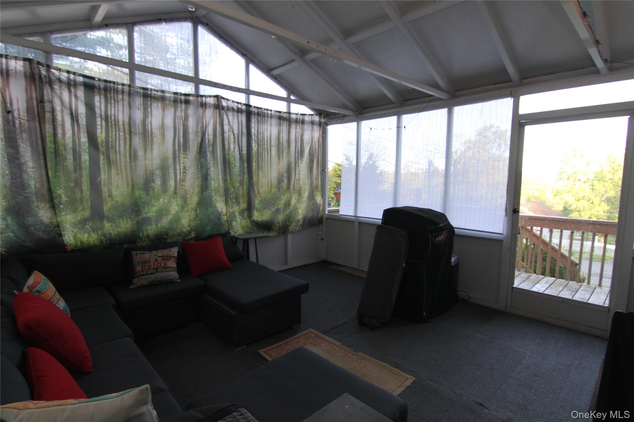 191 Sylvan Lake Road, Unit 16 Hopewell Junction, NY 12533 - Photo 9 of 34 a living room with furniture and a floor to ceiling window