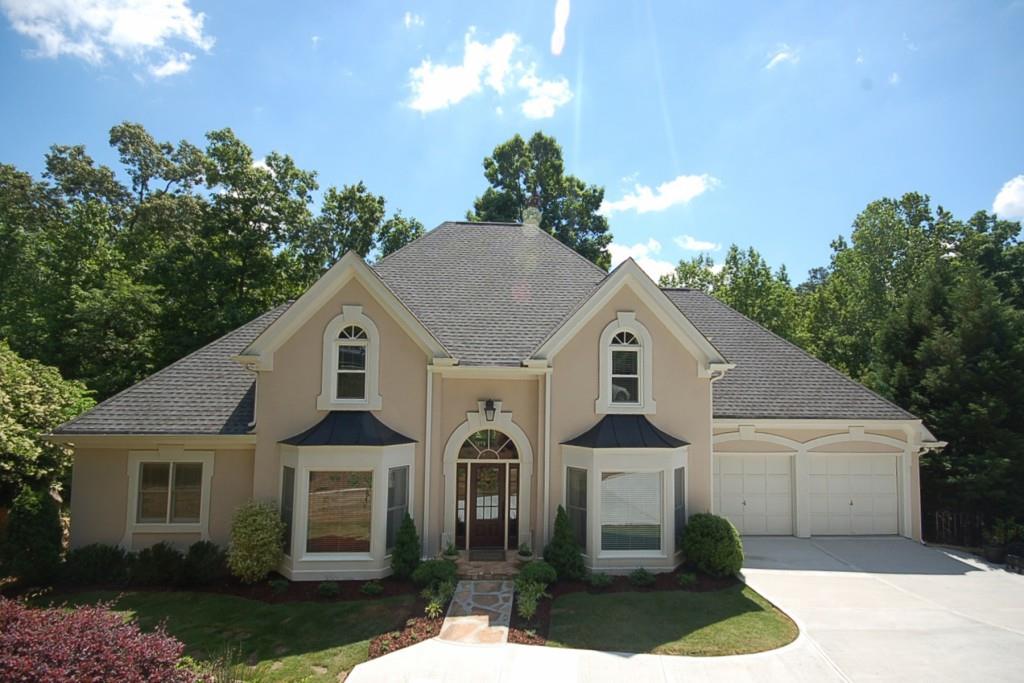 Beautifully updated, spacious, hard coat stucco traditional; open plan; master on main; finished terrace level; sought after Walton HS district!