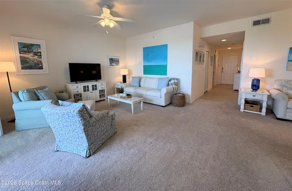 a spacious bedroom with a bed and a chandelier