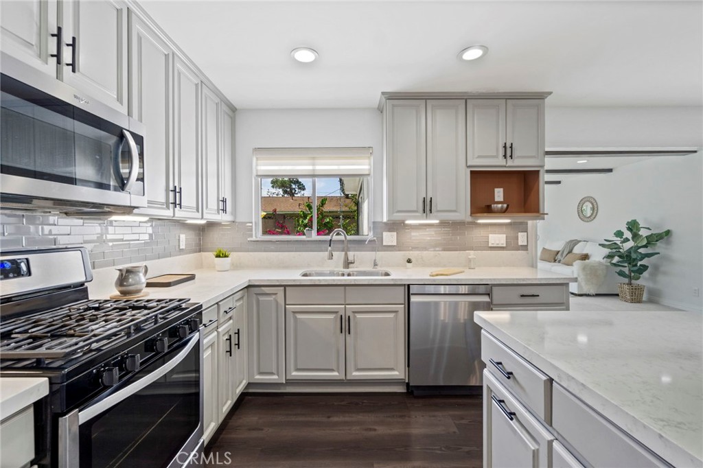 6212 Santa Rita Avenue Garden Grove, CA 92845 - Photo 15 of 50 a kitchen with a sink stove top oven and microwave