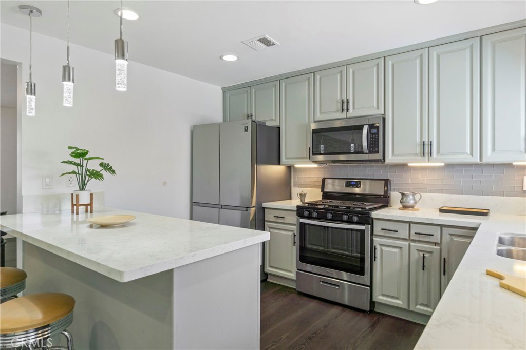 6212 Santa Rita Avenue Garden Grove, CA 92845 - Photo 16 of 50 a kitchen with a stove a sink and a refrigerator