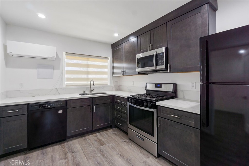 6212 Santa Rita Avenue Garden Grove, CA 92845 - Photo 40 of 50 a kitchen with stainless steel appliances granite countertop wooden cabinets stove top oven and sink