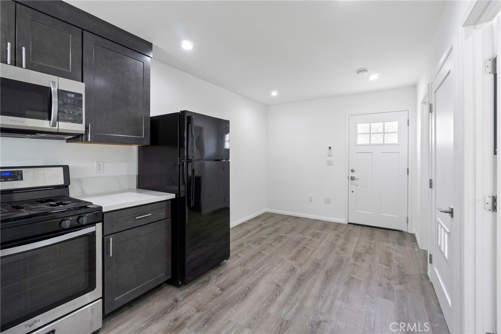6212 Santa Rita Avenue Garden Grove, CA 92845 - Photo 41 of 50 a kitchen with stainless steel appliances granite countertop a refrigerator and a stove top oven