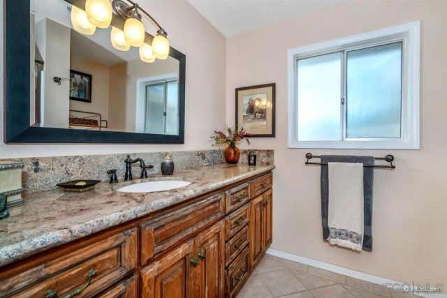 a bathroom with sinks granite vanity and mirror
