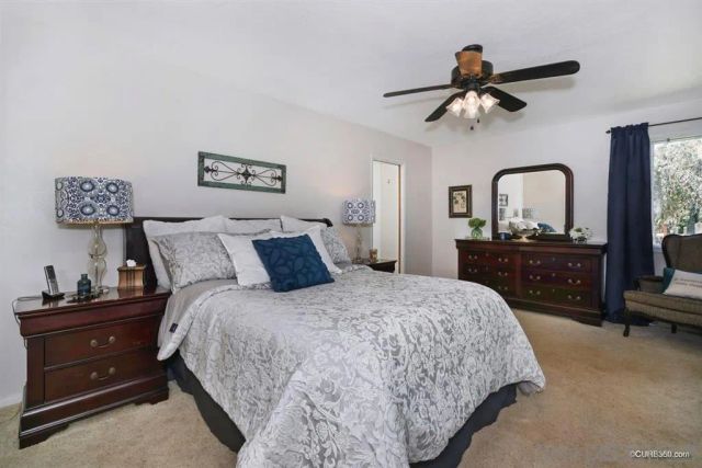 a bedroom with a bed and a dresser