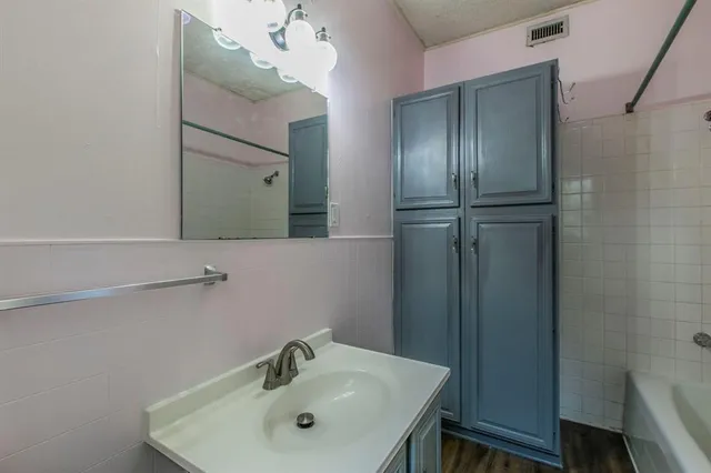 a bathroom with a sink and mirror