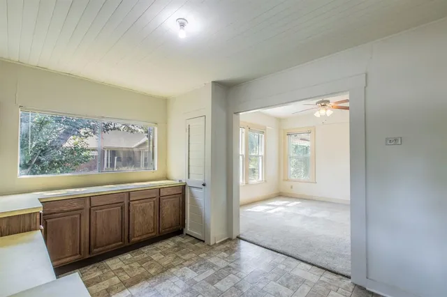a spacious bathroom with a tub sink and mirror