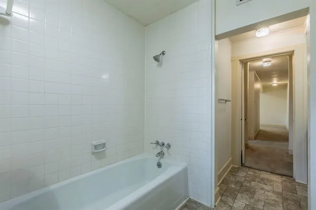 a bathroom with a bathtub and shower