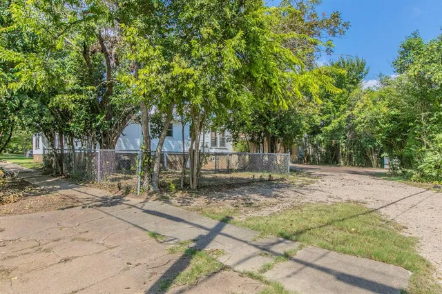 a view of a house with a tree in the background