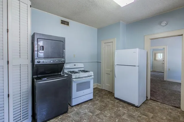 a room with a refrigerator and a stove