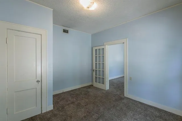 an empty room with closet area