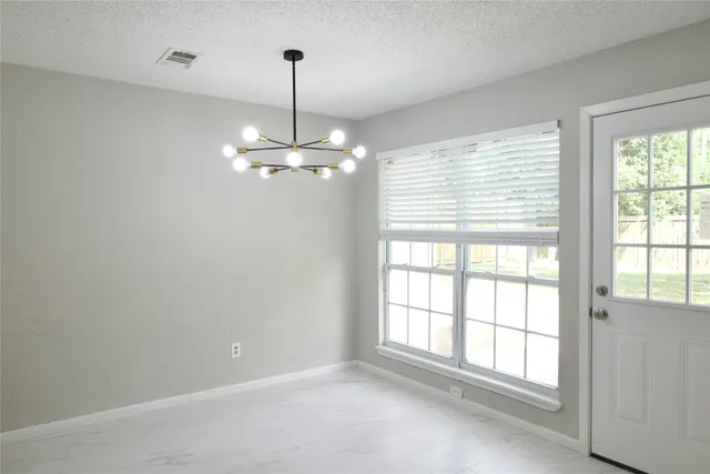 a bathroom with a shower and a glass door