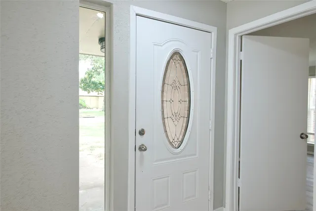 a view of staircase with white walls and white door