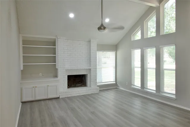 a view of empty room with window and ceiling fan