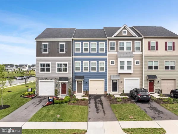 a front view of a residential apartment building with a yard