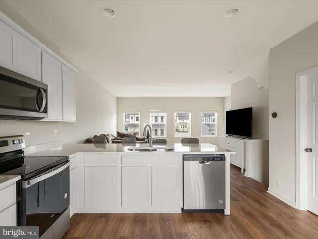 a kitchen with a sink a stove and cabinets