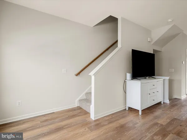 a livingroom with wooden floor and furniture
