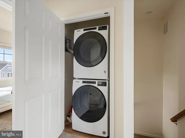a view of a hallway with washer and dryer