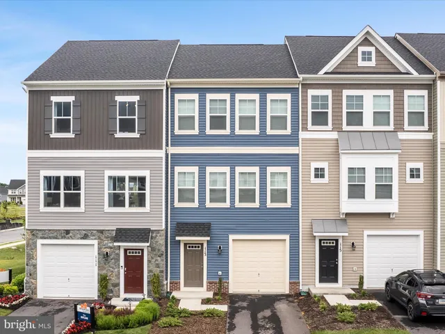 a front view of a residential apartment building with a yard