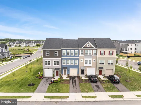 a front view of a residential apartment building with a yard