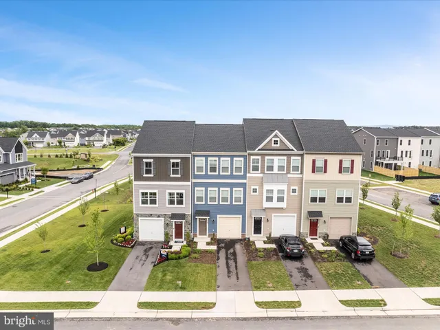 a front view of a residential apartment building with a yard