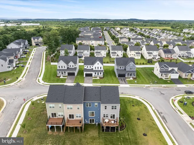 an aerial view of residential houses with outdoor space and swimming pool