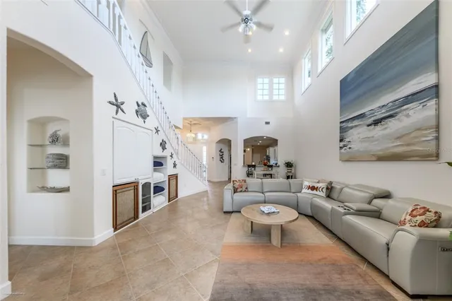 a kitchen with granite countertop a stove a sink and a refrigerator