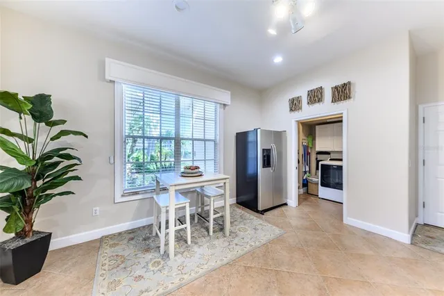 a large bedroom with a large bed a flat tv screen and large windows