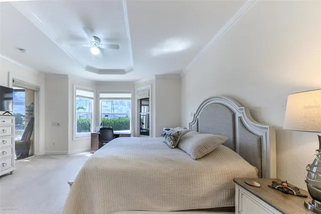 a bedroom with bed and a chandelier