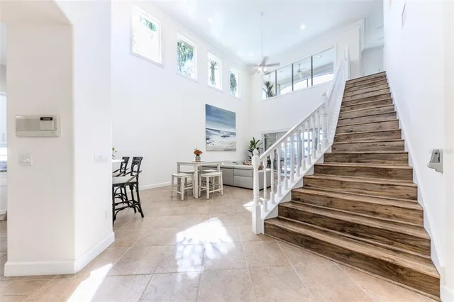 a living room with furniture and large windows