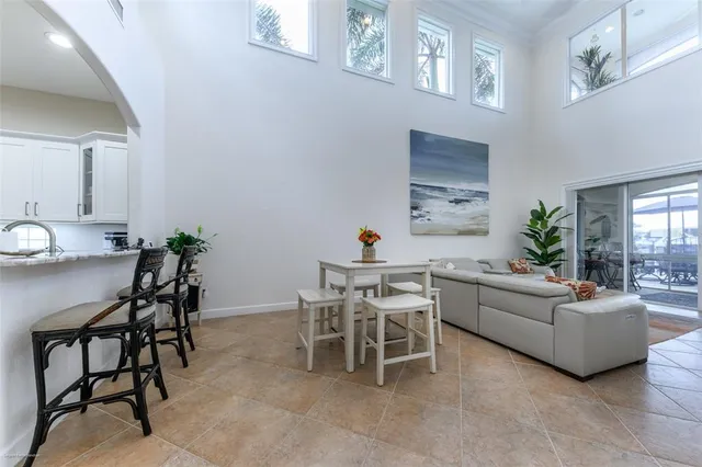 a living room with furniture a rug and a floor to ceiling window